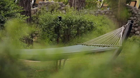 Lonely empty hammock stretched between trees in the woods or in the Park. The Stock Footage 100892719