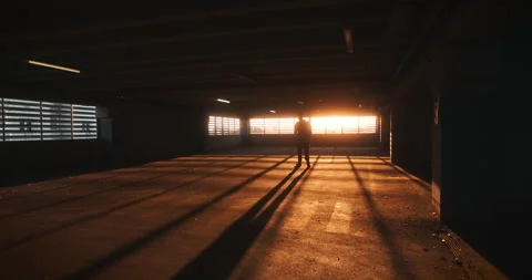 Lonely Figure Walking into Sunset Light Stock Footage 311920473