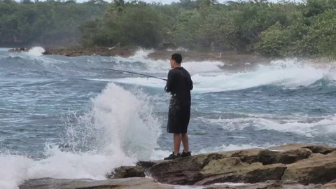 Lonely Fisherman Dramatic Waves Splashing Rocks  4k Stock Footage 219413185