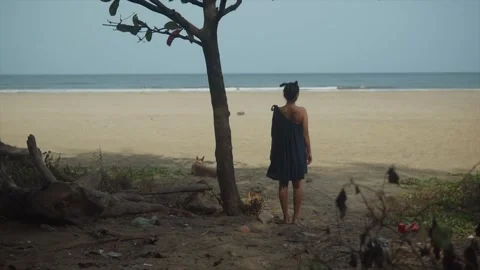Lonely girl staring at the empty beach, deserted person, left alone at Stock Footage 245679344