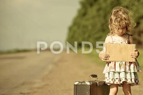 Lonely girl with suitcase standing about road Stock Photos