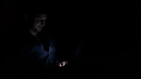 Lonely guy spending time in the dark and chatting on smart phone on social .. Stock Footage 74356886