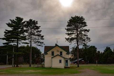 Lonely House at Sunset Between Two Trees Stock Photos