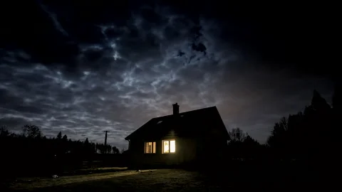 Lonely house under cloudy sky at night. Moon over house. 스톡 동영상 244516501