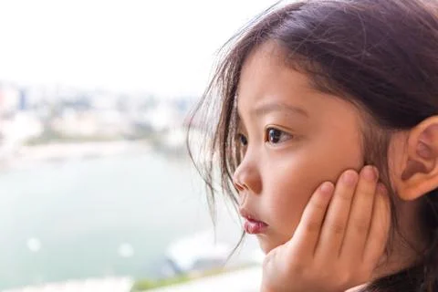 Lonely Kid Looking Through Window Stock Photos