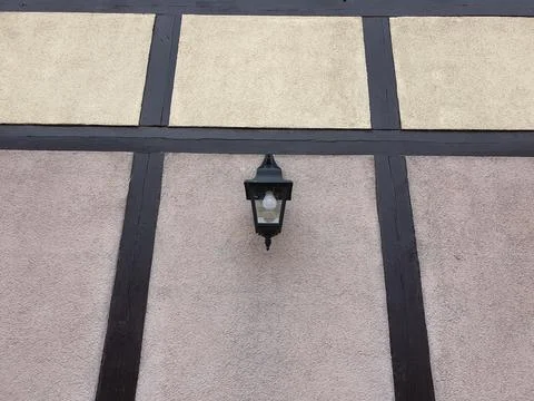 Lonely lantern on the facade of the building Stock Photos