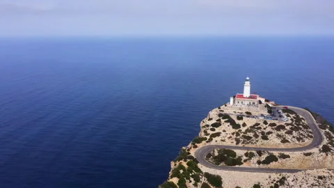 Lonely Lighthouse at Cap de Formentor with serpentine curved asphalt mountain ro Stock-Footage 284056127