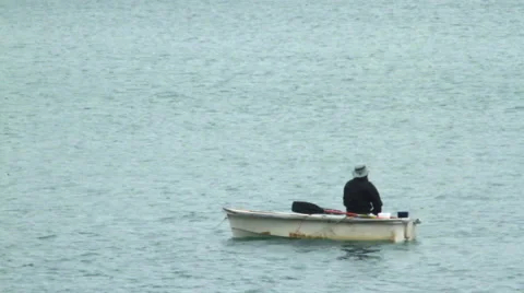 Lonely man on a boat Stock Footage 68784417