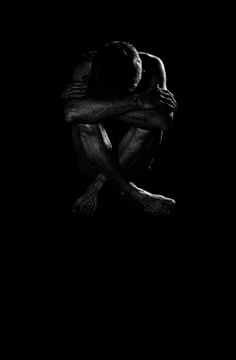 Lonely man in the dark. Stock Photos