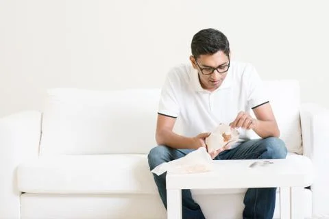 Lonely man eating food alone at home Stock Photos