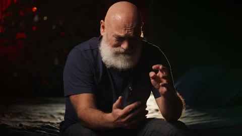 Lonely man in his 50s views photos on phone and cries at home, divorce Stock Footage 346714286