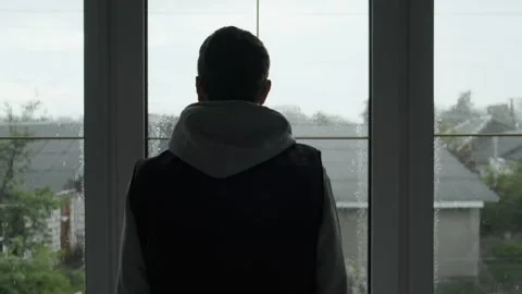 Lonely Man Looking Out the Window on a Rainy Day. Symbol of Sadness, Solitude Stock Footage 309126461