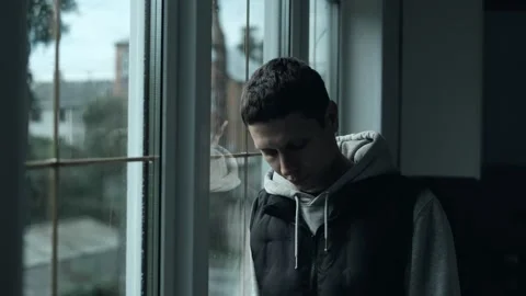 Lonely Man Looking Out the Window on a Rainy Day. Deep Emotional Mood in Natural Stock Footage 309912026