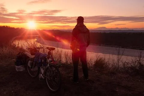 Lonely man with mountain bike at sunset. Concept outdoor recreation Stock Photos