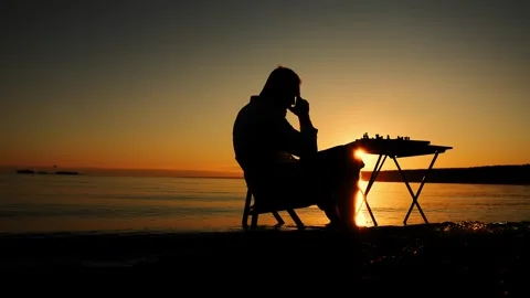 Lonely man playing chess on the beach. Stock Footage 315721630