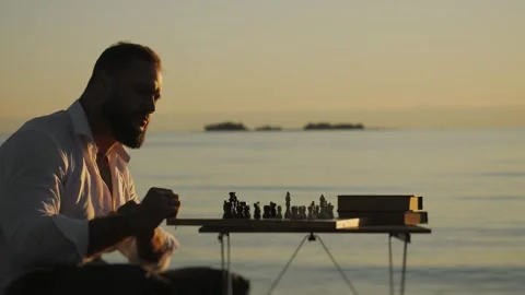 Lonely man playing chess on the beach. Stock Footage 315721692