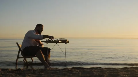 Lonely man playing chess on the beach. Stock Footage 315721881