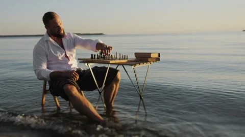Lonely man playing chess on the beach. Stock Footage 315949458