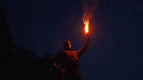 A lonely man with a red torch Stock Footage 221186342