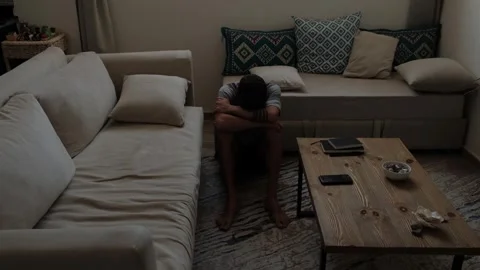 Lonely man sitting between sofas at home, withdrawn after breakup Vídeos de archivo 347303548