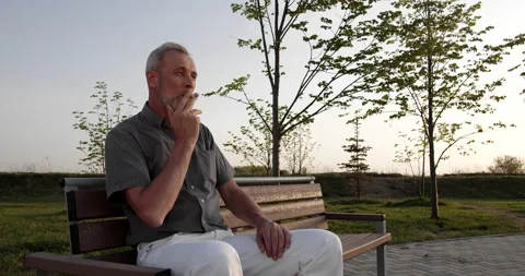 Lonely man smokes on the bench 스톡 동영상 154734927