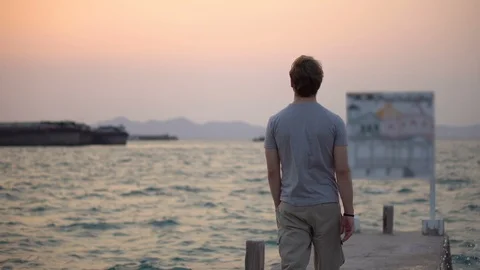 Lonely Man Standing On The Dock, Looking at Sunset - Mindfulness, Contemplation Stock Footage 126259136