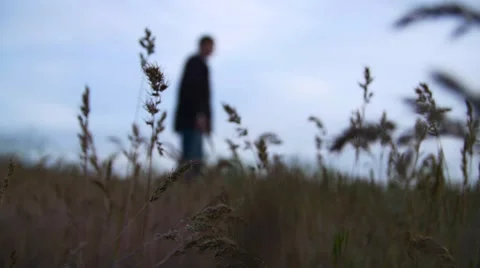 Lonely Man Standing in a Field 動画素材 68781802