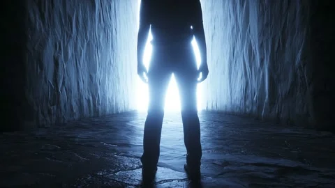 A lonely man stands in front of a light portal. Realistic 4k animation. Stock Footage 145925295