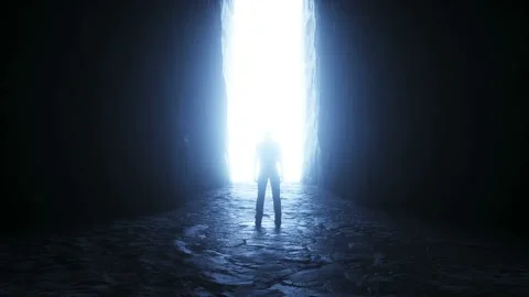 A lonely man stands in front of a moving light portal. Video stock 145925061