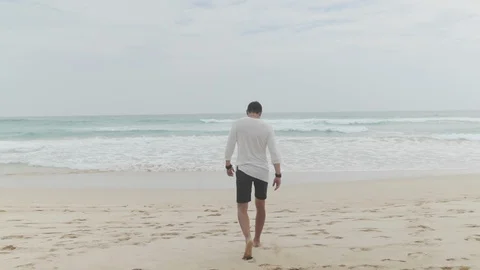 Lonely man walking at beach Stock Footage 109421970