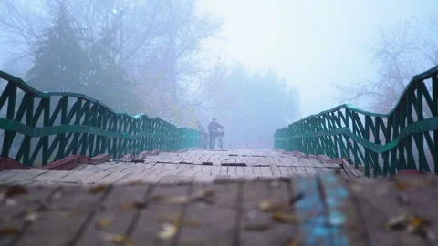 Lonely man walking bridge Stock Footage 81643242