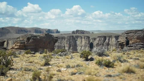 Lonely man walking on the desert at distant view Stock Footage 255896032