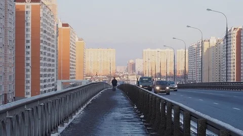 Lonely Man Walking Over a Bridge with Low Traffic On Roads on the Background  스톡 동영상 84695338