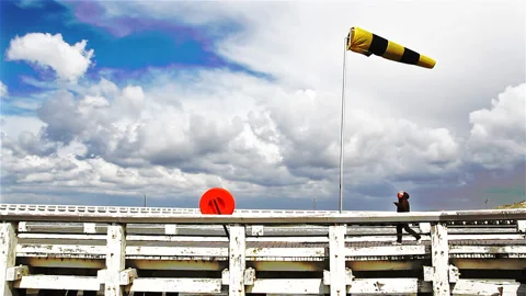 Lonely man walking on a pier by windy weather Stock Footage 89652210