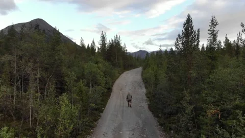A lonely man walks down the road Stock Footage 165076623