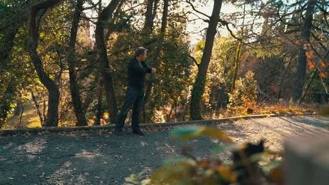 A lonely man walks in the park in the winter on a sunny day, listens to music Stock Footage 121481908