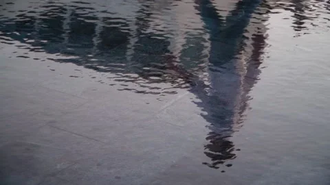 Lonely man walks reflected in the water. An atmosphere of sadness and loneliness Stock Footage 139683278