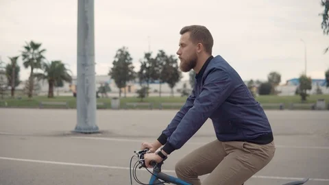Lonely man is working out in daytime, riding a bike in summer Stock Footage 101445767