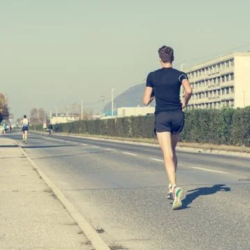 Lonely marahon runner catching up. Stock Photos