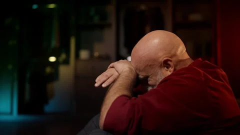Lonely middle-aged man cries while sitting on floor, overwhelmed by despair Stock Footage 342520544