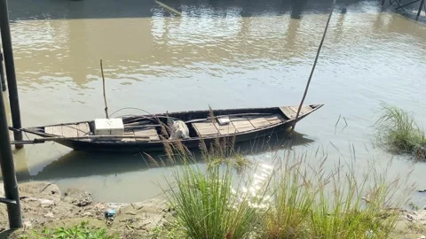 Lonely moored boat floating on river, An empty wooden boat floats, Stock Footage 285663041