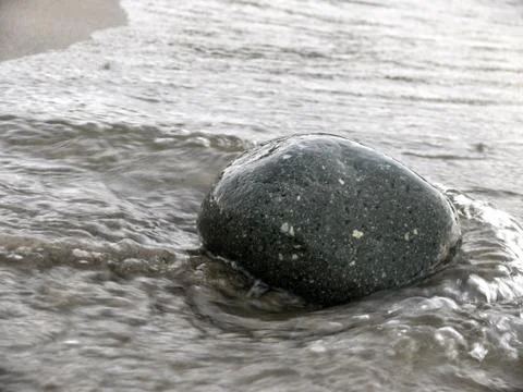 Lonely pebble in sand 写真素材