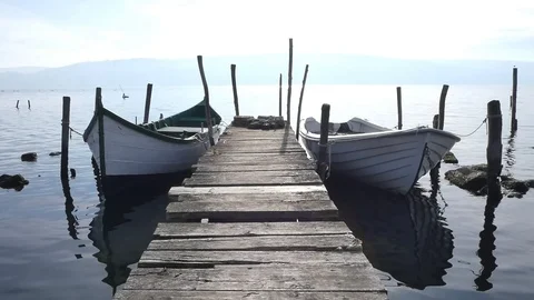 Lonely pier with two boats Stock Footage 121376243