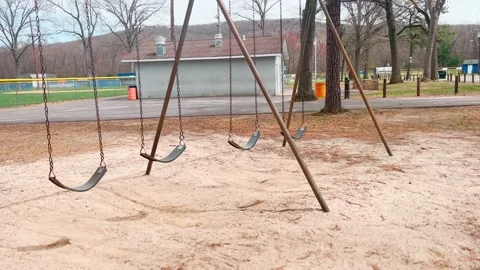 LONELY PLAYGROUND SWING IN MOTION Stock Footage 182480614