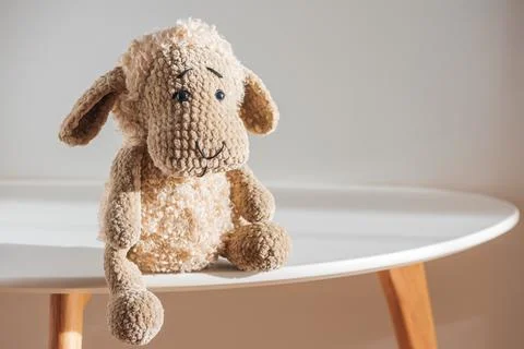 Lonely Plush Sheep on Minimal Table in Soft Light Stock Photos