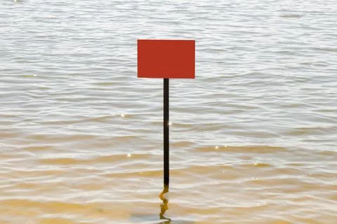 Lonely red empty warning sign on the water in the Dnieper river in Ukraine .. Stock Photos