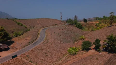 The Lonely Road: Winding Through a Dry Mountain Range Stock Footage 301700243