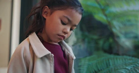 Lonely, sad and child by window in home with reflection of trauma, bad memory Stock Footage 336628294
