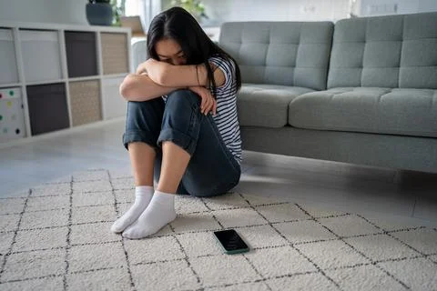Lonely sad asian woman suffering on floor looks devastated mental trouble bad Stock Photos