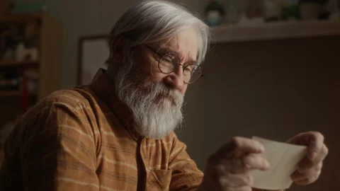 Lonely Senior Man Looking at Old Photo Crying from Grief Stock Footage 337580979